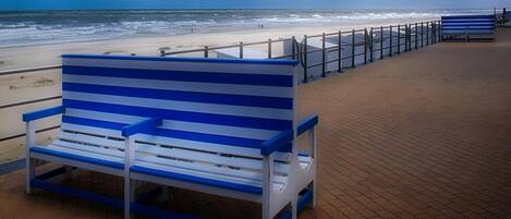 A beachside bench with a view of the ocean.