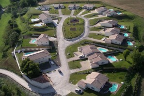 A residential area with multiple houses, each with a swimming pool.