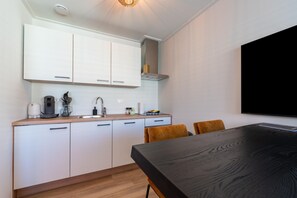 Fridge, stovetop, dishwasher, coffee/tea maker