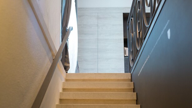 A staircase with a handrail and a light-colored wall. - BASTINICA KRK Superior Ap 3, OldTown, CityCenter (Krk)