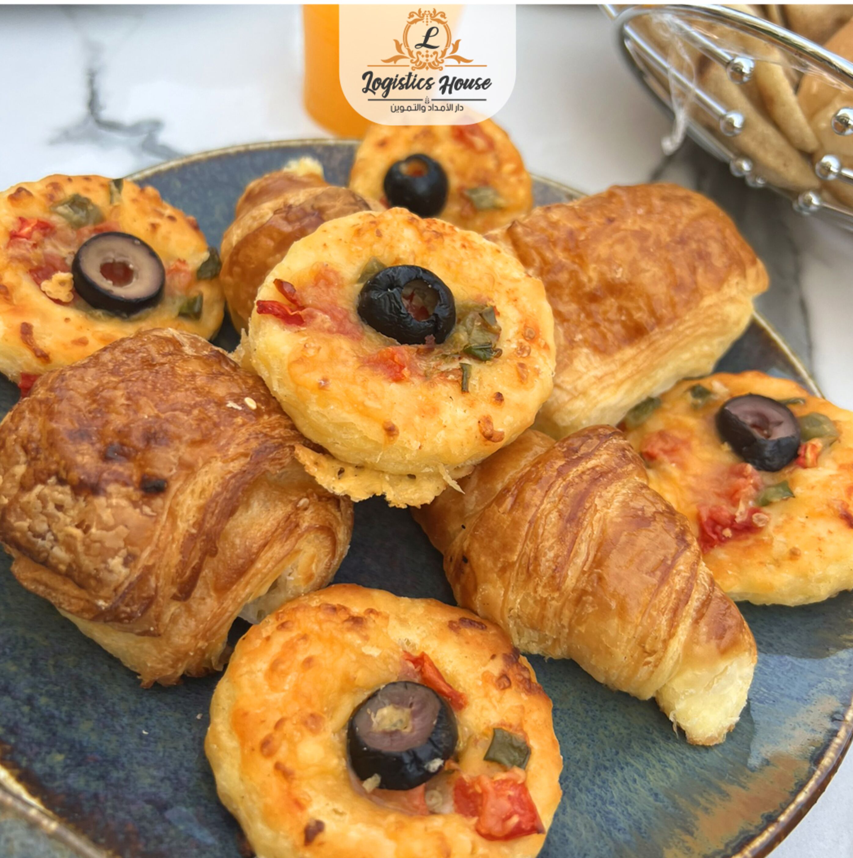 A plate of pastries with olives and vegetables.