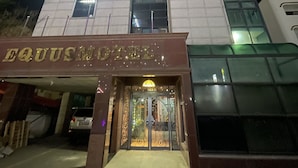 A hotel with a modern design, featuring a prominent entrance with a glass facade and a well-lit signboard. - Equus Motel (Jincheon)