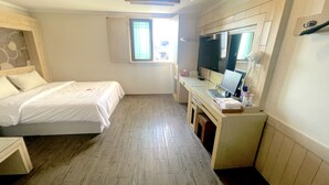 A bedroom with a bed, a desk with a computer, and a window. - Equus Motel (Jincheon)