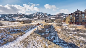 A mountainous landscape with a snow-covered path leading to a building with multiple windows and balconies. - All-season Heber City Condo w/ Stunning Views! (Heber City)