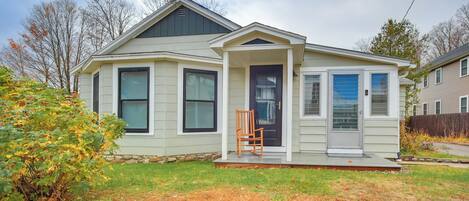 A single-story house with a front porch, a small entryway, and a garage.