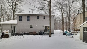 A two-story house with a covered porch and a swing set in the yard. - Pennsylvania Home w/ Hot Tub: 7 Mi to Kalahari! (Tobyhanna)