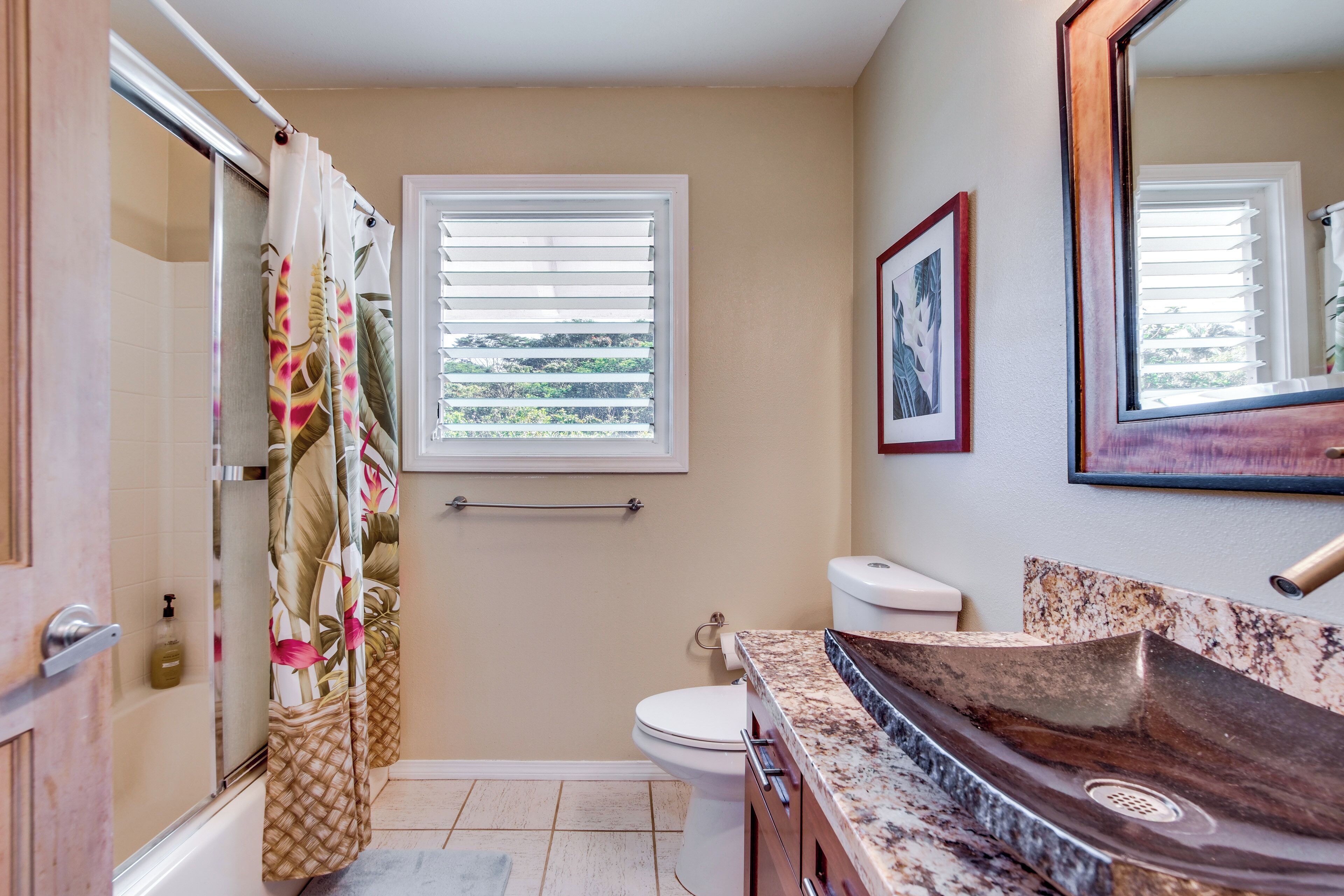 A bathroom with a shower, toilet, and sink.