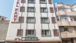 A multi-story hotel with a sign reading "HOTEL KANT" and "RESTAURANT" indicating a dining facility within. - Hotel Kant by GoHotels - Near Shree Dwarkadhish Temple (Dwarka)