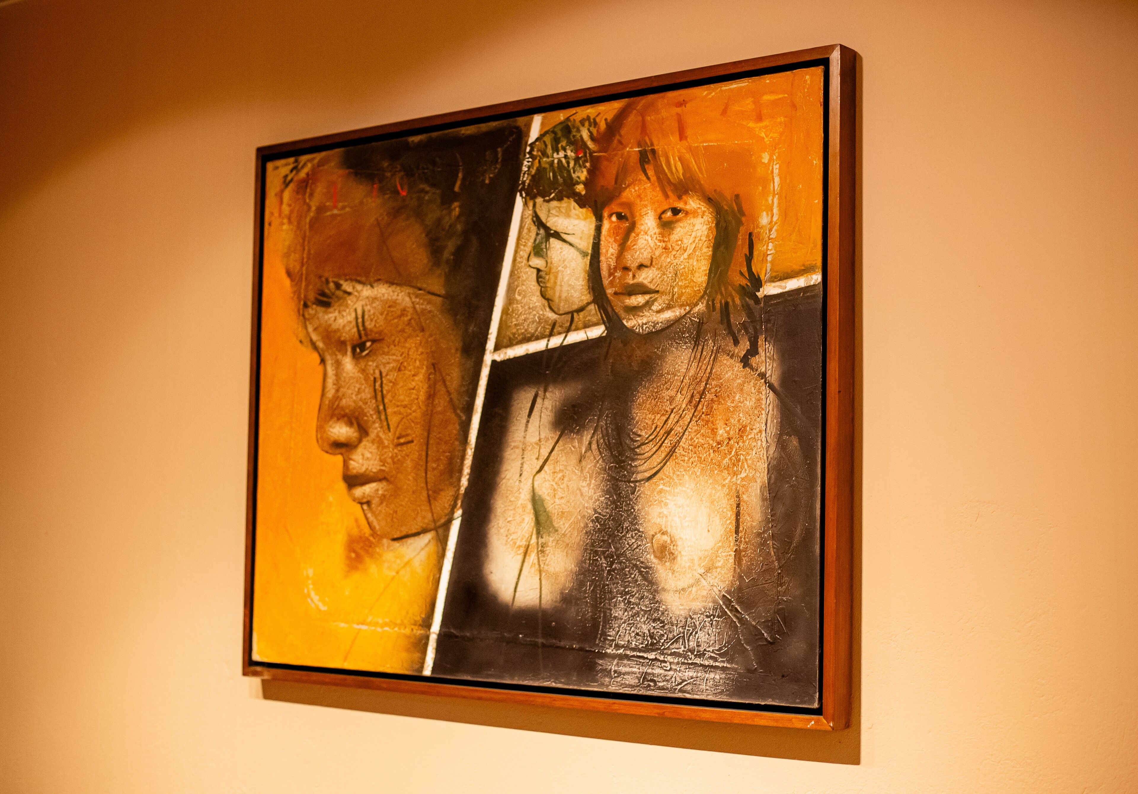A framed artwork on a wall.