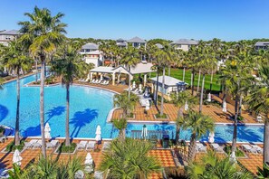 A resort with a large pool, palm trees, and lounge chairs. - GORGEOUS 4/4 SLEEPS 10! GULF VIEW FROM 3rd FLOOR! NEWLY FURNISHED!!! ONE BLOCK FROM BEACH ACCESS! (Panama City Beach)