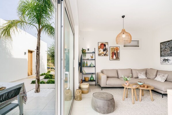 A modern living room with a sofa, coffee table, and decorative items.