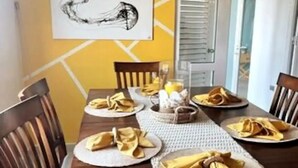 A dining table set with plates, napkins, and a centerpiece.