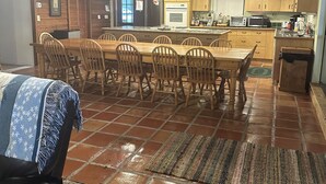 A spacious kitchen with wooden cabinets, a dining area with a large table and chairs, and a rustic ceiling. - Spacious retreat on beautiful Lake June. Lake Placid, FL (Lake Placid)