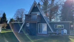A two-story house with a balcony, a covered patio, and a small deck. - Family Retreat at Conneaut Lake, PA ideal for family fun or relaxing get- away!  (Conneaut Lake)