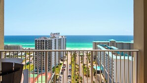Ein Balkon mit Blick auf das Meer und angrenzende Gebäude.