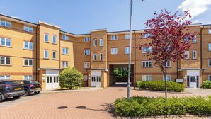 A multi-story residential building with a brick facade, multiple windows, and a central entrance. - Skyline Haven Modern 2BR w/ Free Parking & 4kTV (London)