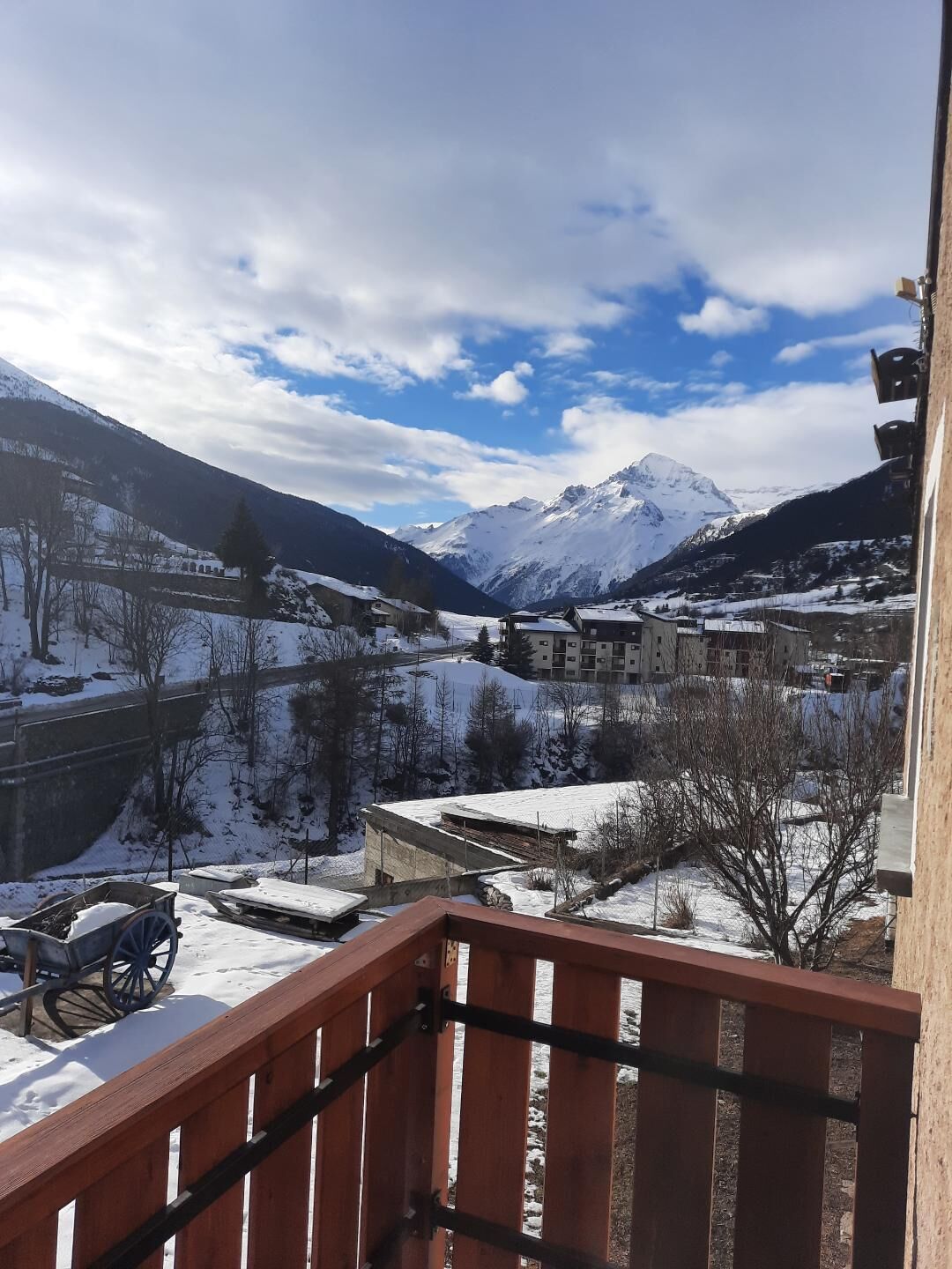 A snowy mountain landscape with a town in the valley.