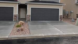 A two-story house with a garage on the left and a driveway leading to the front door. - Cute Modern townhouse close many Utah national parks (Cedar City)