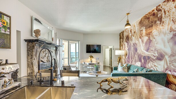 A modern kitchen with a marble countertop, a coffee machine, and a leopard statue. - Luxe Long Beach Condo w/ Pool: 1 Mi to Shoreline! (Long Beach)