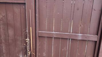 Een houten poort met een metalen grendel.