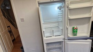 A white refrigerator with multiple compartments, including a freezer and a milk shelf. - Cozy Room A @ Shiremoor (Shiremoor)