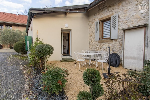 Enjoy outdoor dining or relaxation at this charming property, surrounded by a beautifully maintained garden.
