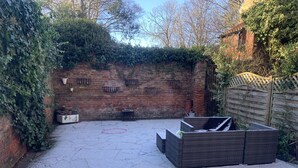 A brick wall with metal baskets and a white planter box. - Central Beverley 4-bedroom Townhouse (Beverley)