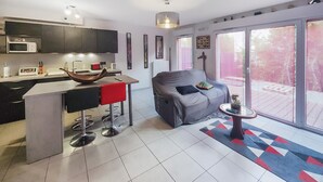 A modern kitchen with a dining area, a sofa, and a view of the outdoors. - Pet friendly home in Agde with WiFi (Agde)