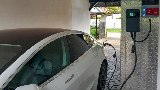A car charging at a public electric vehicle charging station.