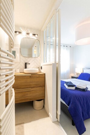 Cozy retreat with a bed, vanity, and window.