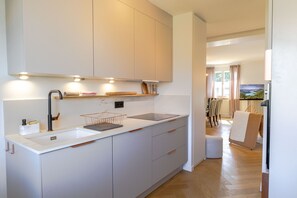 Modern kitchen with a sink and range hood, perfect for cooking and dining.