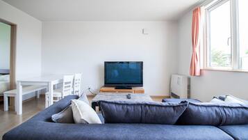 Basic Apartment | Living area | Flat-screen TV