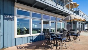 A seaside restaurant with outdoor seating and large windows overlooking the ocean. - Beachfront Rio Del Mar Home - 5 bedrooms! (Aptos)