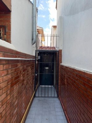 Stroll through a charming alleyway to an entrance.