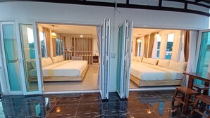 A modern hotel room with a large bed, a smaller bed, and a seating area. - Habor House by Koh Larn Riviera (Koh Lan)