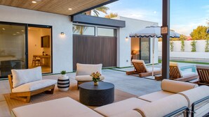 A modern outdoor patio with seating, a pool, and a covered area. - The Reserve at Polo Villas #16 | Sleeps 18 • Grand La Quinta Villa • Pool + Spa (La Quinta)