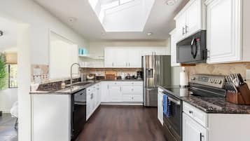 Fridge, stovetop, dishwasher, coffee/tea maker