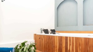 A bathroom with a wooden vanity, a sink, and a mirror.