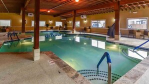An indoor swimming pool with a wooden ceiling, clear pool area, and seating by the pool. - Waterfront Ocean Villa! (Ocean City)