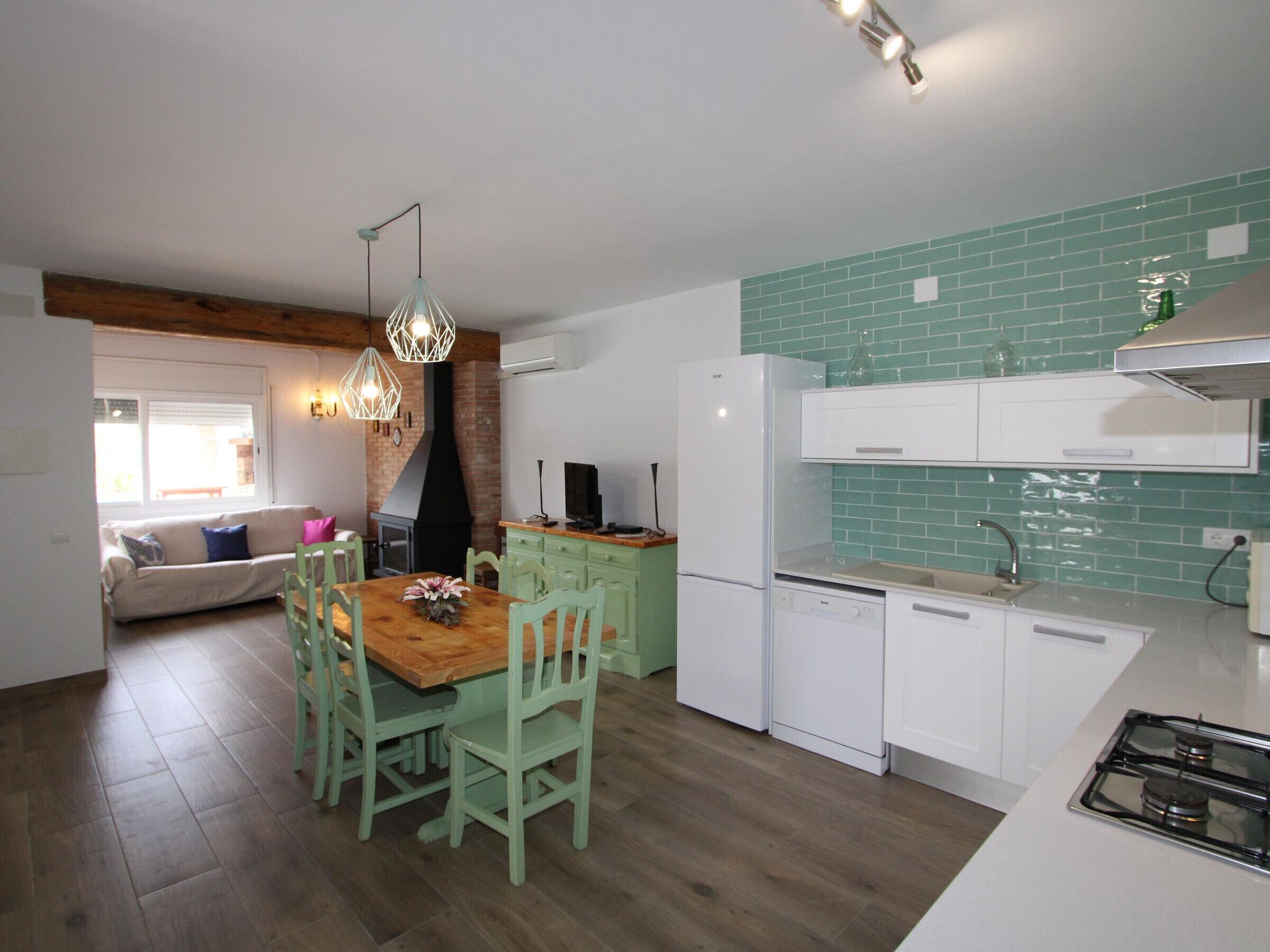 A compact kitchen with a dining area, a built-in oven, and a gas stove.