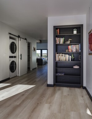 Cozy retreat with a personal touch, featuring a bookshelf filled with books and decorative items.