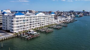 A large hotel with multiple balconies and a marina with boats. - Bahia Vista I 508-Baywater 10th St, Free WiFi, Pool, Elev, W/D, AC (Ocean City)