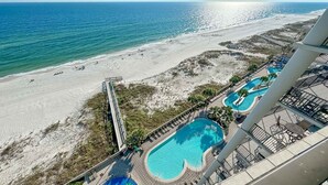 A resort with a beach view, a pool area, and a lifeguard stand. - Beachfront!! Lazy River and Slide!!  New Rental!! (Orange Beach)