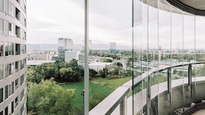 A modern building with large windows and a view of a cityscape. - Slavic Industrial Apartment by CHORS (Bratislava)