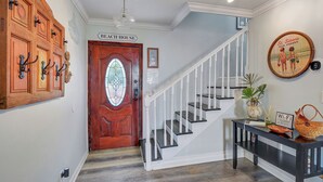 A staircase with white railings leading to a door labeled "Beach House." - 0.1 Miles to Beach • Pet Friendly •  Walk to King & Prince • 2 Master Suites (St Simons Island)