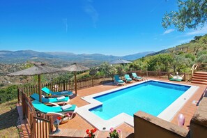 A pool area with lounge chairs and a view of the countryside. - Amazing villa. Impressive views. (Comares)
