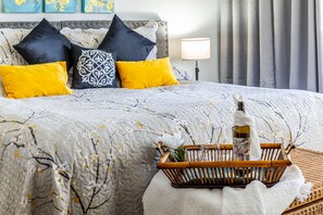 Relax in comfort with a neatly arranged bed, decorative headboard, and convenient bedside table.