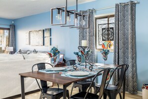 Enjoy meals in the dining area with a table for two and a decorative centerpiece.