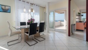 A dining area with a table, chairs, and a view of the outdoors.