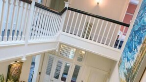 A multi-level staircase with white railings and dark wooden steps. - House of the Northern Gate (Thurso)